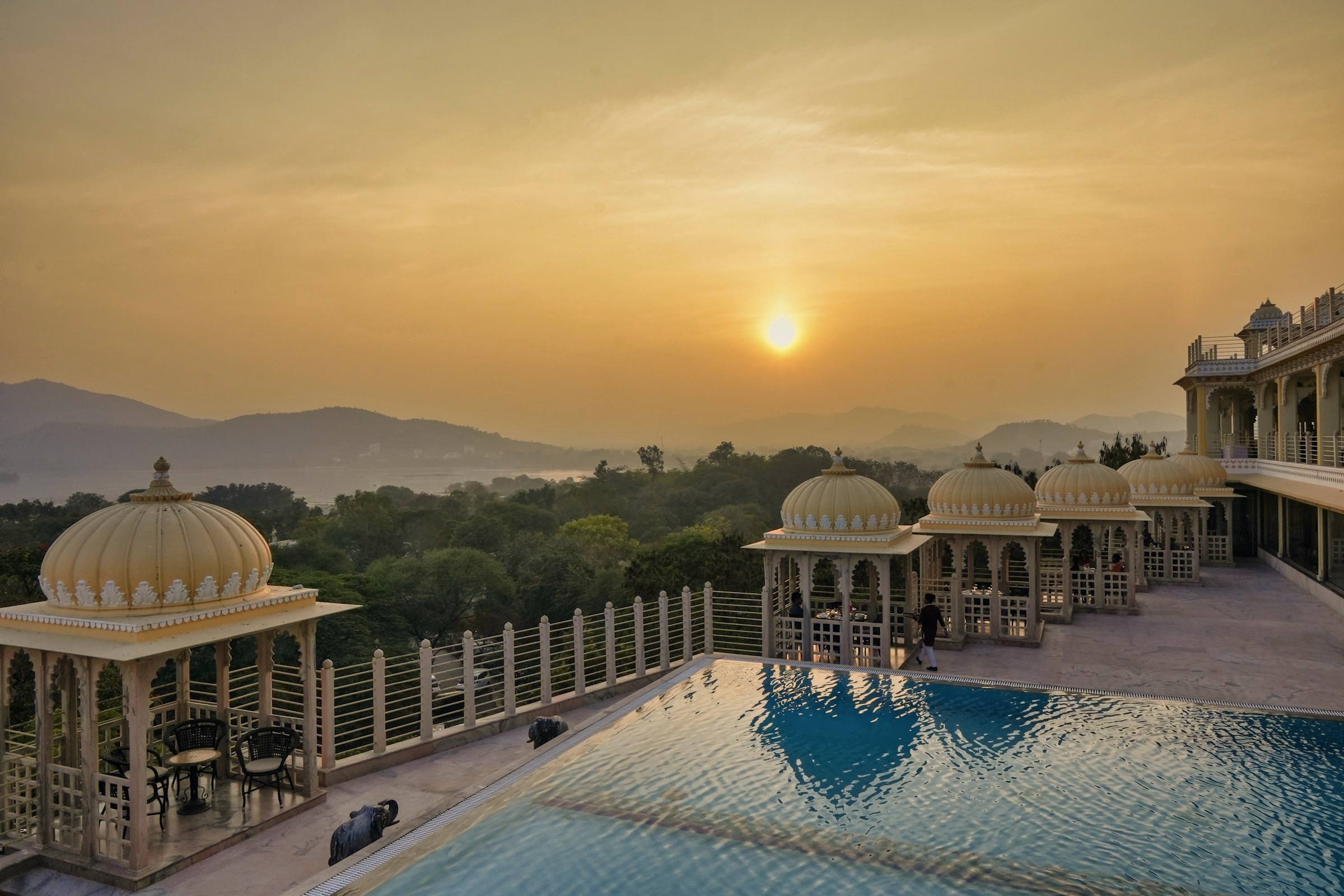 A palace-hotel pool at sunset